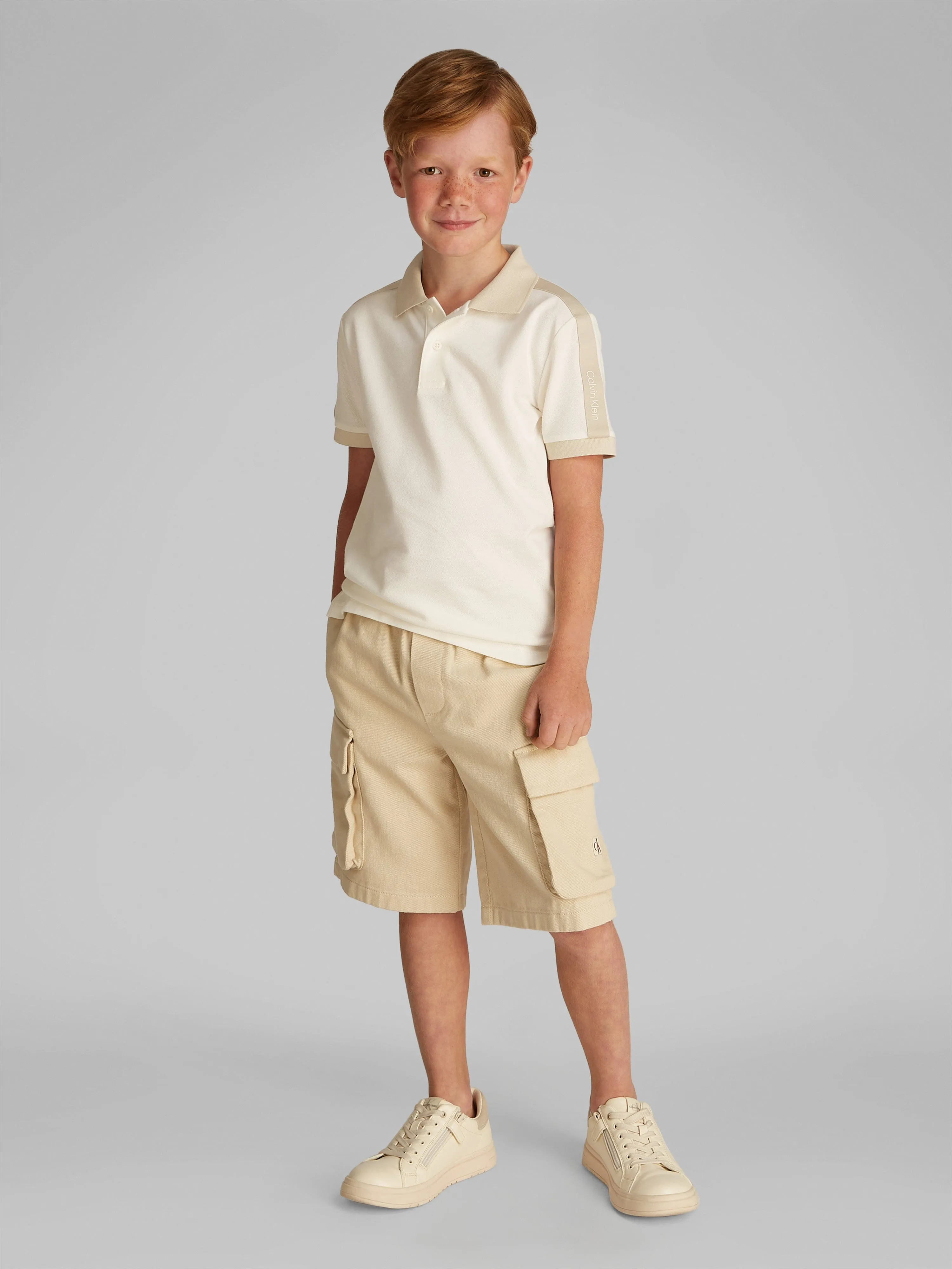 Jungen Piqué-Streifen-Polohemd in Beige